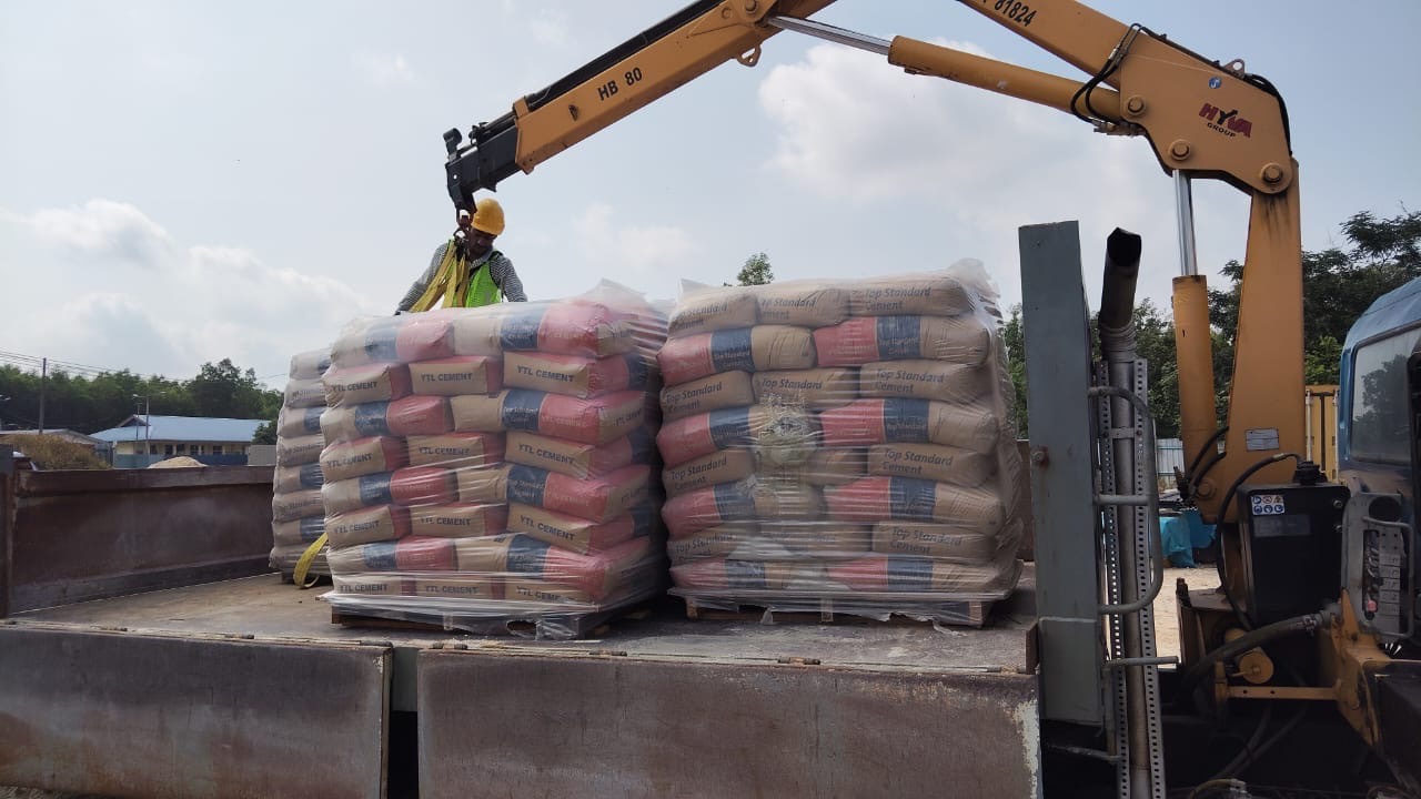Palletised cement prepared for crane-truck delivery in Kluang